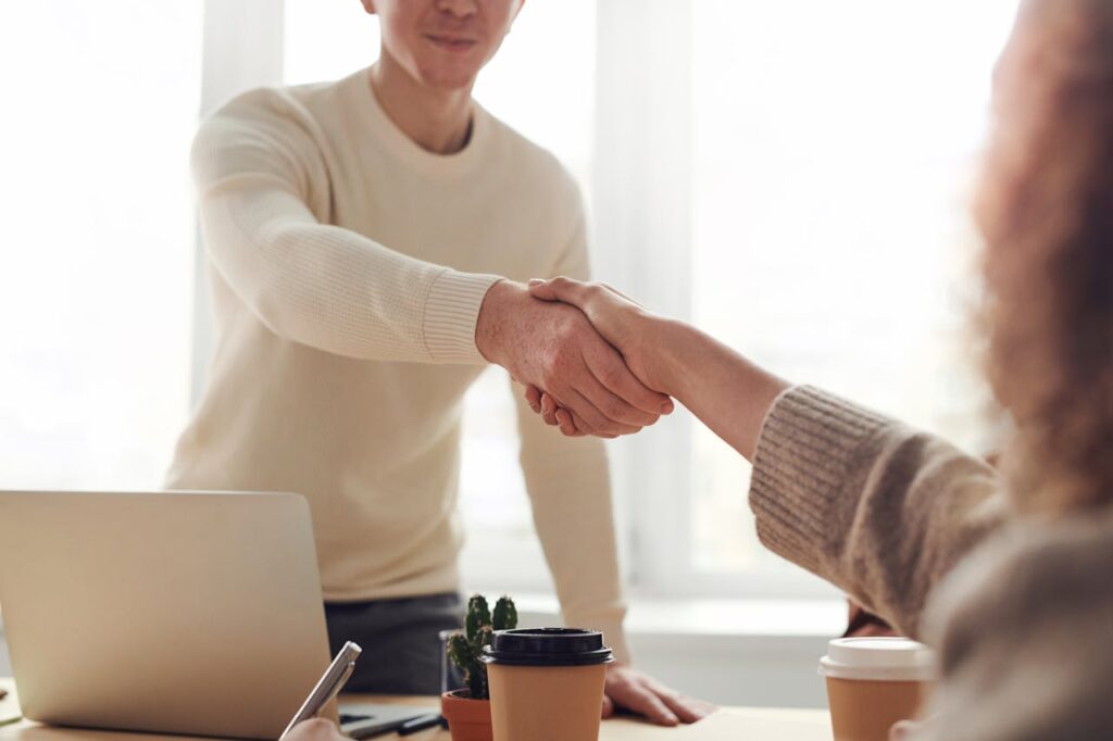 Two young-people shaking their hands